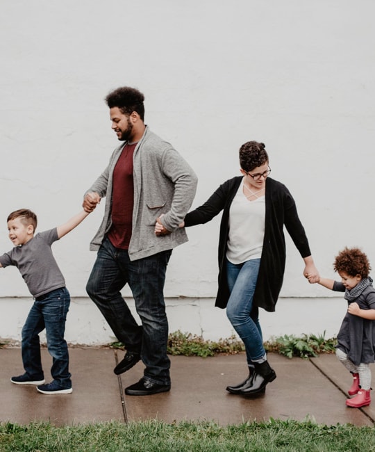 an image of a family holding hands